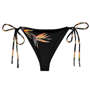 May include: Black bikini bottom with a tropical bird of paradise print and tie sides.