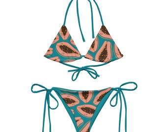 May include: A turquoise bikini with a papaya print. The top is a triangle style with adjustable straps and ties at the back. The bottom is a cheeky style with ties on the sides.