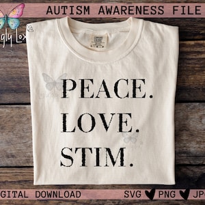 May include: Cream-colored t-shirt with the words "PEACE. LOVE. STIM." in black, promoting autism awareness. The shirt also features the text "AUTISM AWARENESS FILE" and "DIGITAL DOWNLOAD".