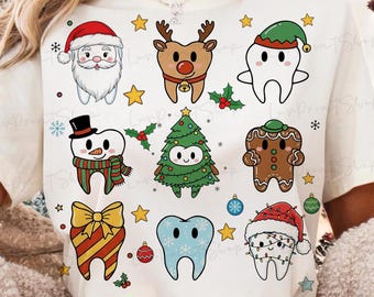 May include: White t-shirt featuring cartoon illustrations of Christmas-themed teeth, including Santa, a reindeer, a snowman, and a gingerbread person. The design includes stars, holly, and ornaments.
