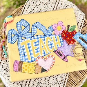 May include: A yellow rectangular sign featuring the word TEACH in yellow letters, decorated with a blue gingham ribbon, a red apple, a pink flower, a purple star, a pink heart, and a yellow pencil with a pink eraser and floral pattern.