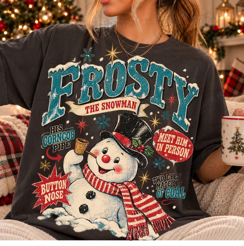 May include: A charcoal gray t-shirt featuring a graphic of a snowman wearing a black top hat and a red and white striped scarf. The text reads FROSTY THE SNOWMAN, HIS CORNCOB PIPE, BUTTON NOSE, MEET HIM IN PERSON, and TWO EYES MADE OUT OF COAL.