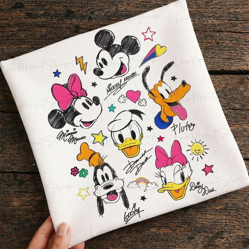Puede incluir: Tela blanca con ilustraciones de dibujos animados de Mickey Mouse, Minnie Mouse, Donald Duck, Daisy Duck, Goofy y Pluto. El dise&ntilde;o incluye estrellas de colores, corazones y un arco&iacute;ris, con los nombres de los personajes en cursiva.