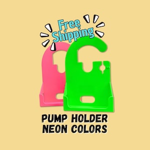 May include: Two neon-colored pump holders, one pink and one green, are displayed against a light yellow background. The text "Free Shipping" is above the holders, and the text "PUMP HOLDER NEON COLORS" is below.