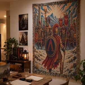 May include: A rectangular woven wall tapestry featuring a detailed illustration of a Spartan warrior in the foreground with a red cape and a shield displaying a large Greek letter Lambda, followed by a line of Roman soldiers with banners and spears.