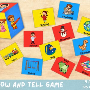 May include: A colorful educational game with a cube and flashcards. The flashcards feature illustrations of a train, doctor, swing, bag, snowman, world, dinosaur, shoes, and more. The text "SHOW AND TELL GAME" is also visible.