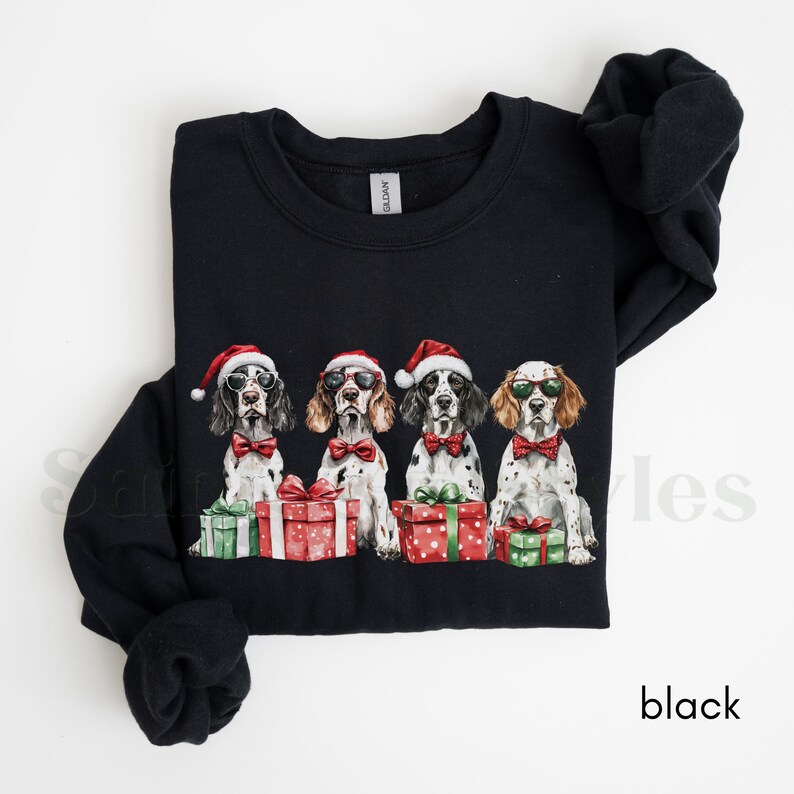May include: Black Christmas sweatshirt with four dogs wearing Santa hats and sunglasses, each holding a gift box. The dogs are all wearing bow ties.