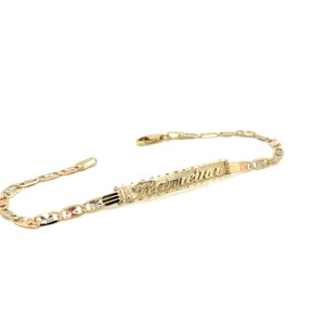 May include: A gold bracelet with a nameplate that reads "Romeina". The bracelet is made of three different colors of gold: yellow, white, and rose.