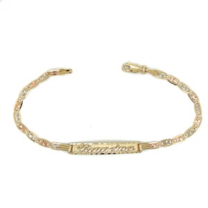 May include: A gold bracelet with a nameplate that says "Samantha". The bracelet is made of three different colors of gold: yellow, white, and rose.