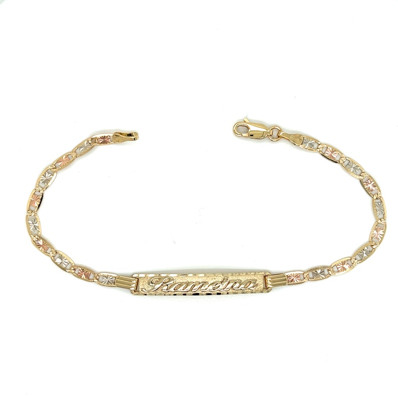 May include: A gold bracelet with a nameplate that says "Samantha". The bracelet is made of three different colors of gold: yellow, white, and rose.