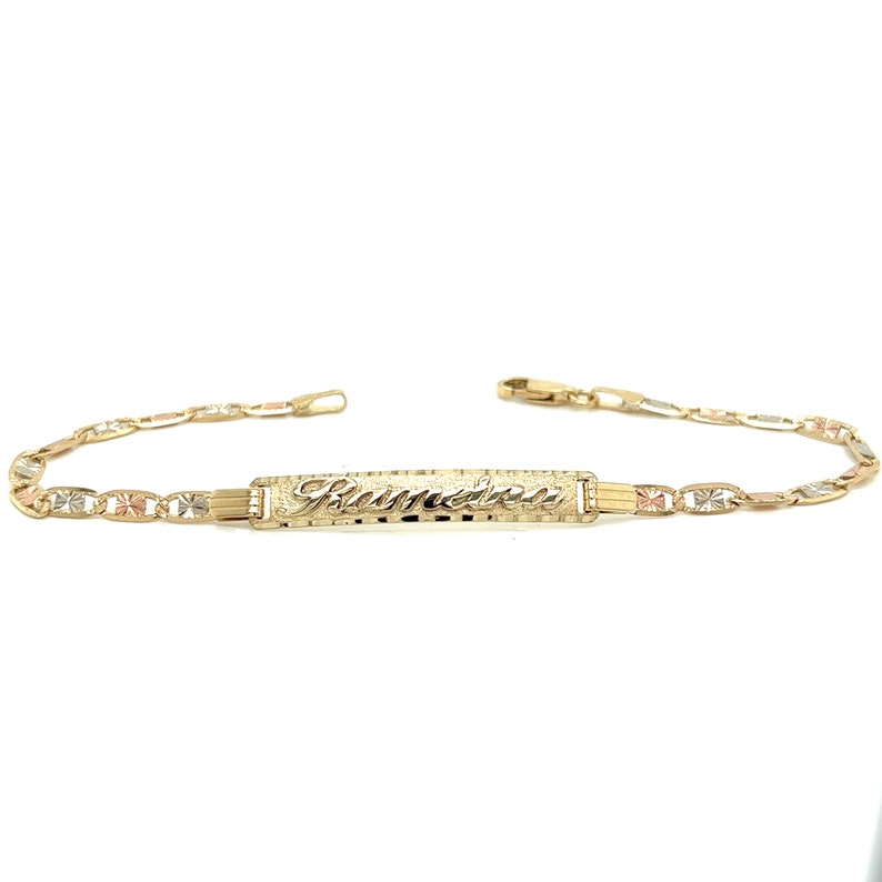 May include: A gold bracelet with a nameplate that reads "Pamela". The bracelet is made of three different colors of gold: yellow, white, and rose.