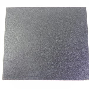 May include: Two gray, textured, square sheets of material are stacked on a white background. The sheets have a speckled appearance and a slightly rough surface. The edges are clean and straight.