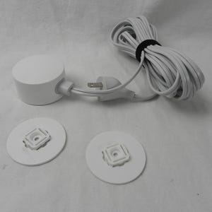 May include: White wireless security camera with a white power adapter and cord. The camera comes with two white mounting plates.