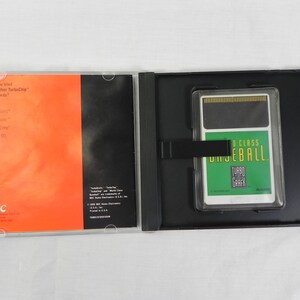 May include: An open black case containing a TurboGrafx-16 video game cartridge labeled "World Class Baseball" and a booklet with orange and black panels. The booklet has the NEC logo and text.