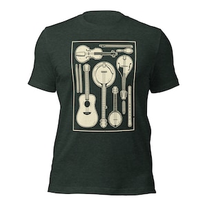 May include: A dark green t-shirt featuring a white graphic of various musical instruments, including a guitar, banjo, violin, mandolin, and a flute. The instruments are arranged within a rectangular frame.