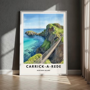 May include: A framed watercolour print of Carrick-a-Rede, Northern Ireland. The image shows a rope bridge over turquoise water and green cliffs. The text "CARRICK-A-REDE NORTHERN IRELAND" is printed at the bottom of the frame.
