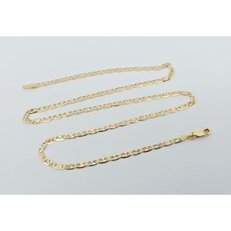 May include: A gold-colored chain necklace with a mariner link design. The chain is displayed on a light gray background. The necklace has a lobster claw clasp.