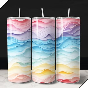 May include: Three stainless steel tumblers with a colorful abstract wave design. The tumblers are pink, blue, yellow, and purple.