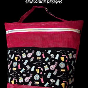 Hot Mesh Project bag designed and sewn by Linda C of Sewcookie Designs.  This project bag has a divided on the front with accent binding on the top of pocket.  Luggage strap on back