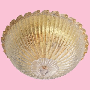 May include: A gold-toned glass ceiling light fixture with a scalloped edge and a textured, ribbed design.