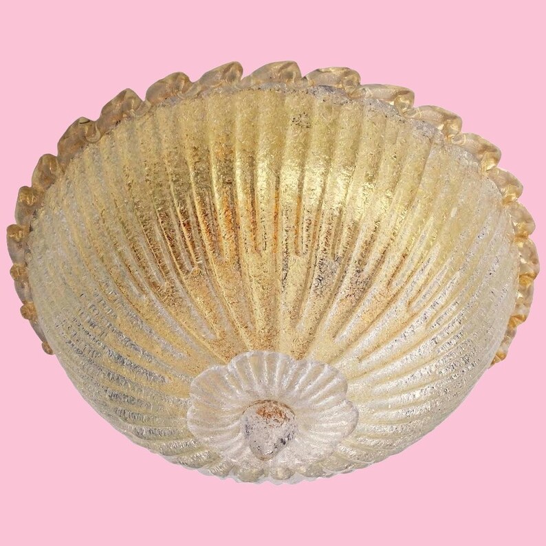 May include: A gold-toned glass ceiling light fixture with a scalloped edge and a textured, ribbed design.