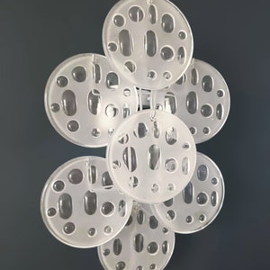 May include: A set of seven white, round, decorative wall sconces with a unique, textured, bubble-like design.