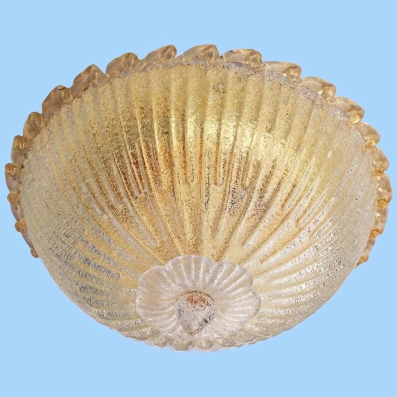 May include: A gold-toned glass ceiling light fixture with a scalloped edge and a textured, ribbed design.