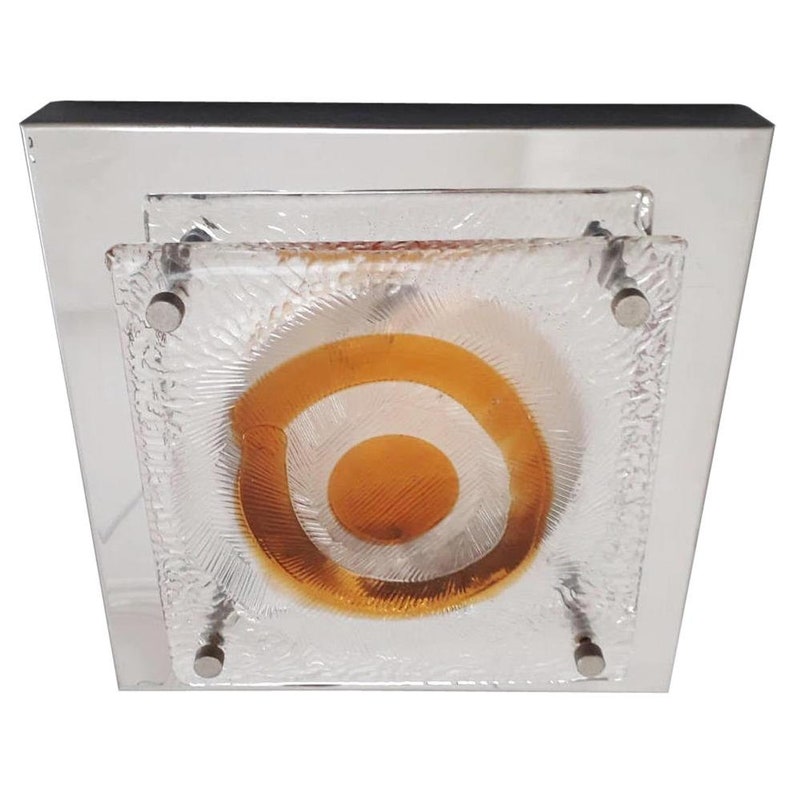 May include: A square ceiling light fixture with a chrome frame and a frosted glass shade with a concentric circle design in shades of orange and white.