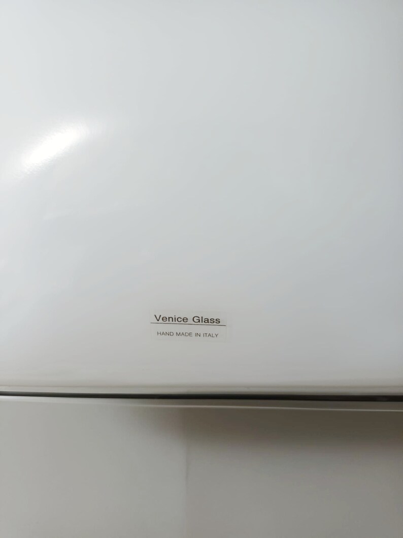 May include: White appliance with a black label that reads "Venice Glass" and "Hand Made in Italy".