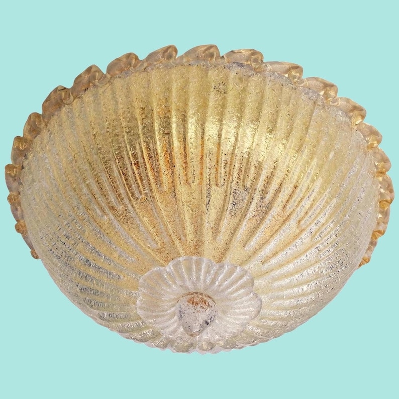 May include: A gold-toned glass ceiling light fixture with a scalloped edge and a textured, ribbed design.