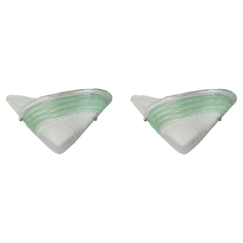 May include: A pair of vintage wall sconces with a white and green glass design. The sconces have a triangular shape and a layered glass design.