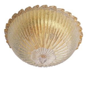 May include: A gold and white glass ceiling light fixture with a scalloped edge and a textured surface.