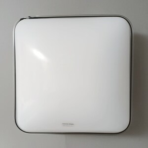 May include: A white square ceiling light fixture with a black trim and the text "Venice Glass" on the bottom.
