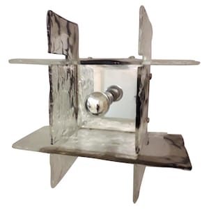 May include: A clear glass cube light fixture with a frosted finish and a silver knob. The cube is made up of six individual pieces of glass.