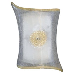 May include: A decorative wall sconce with a unique, hourglass-like shape. The sconce features a textured, frosted glass design with a silver-gray border and a central, flower-like accent in a golden hue. The sconce is designed to be mounted on a wall.