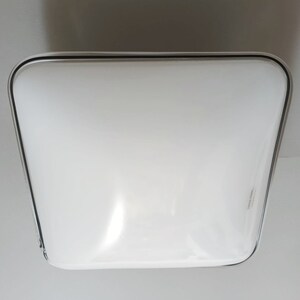 May include: A white square ceiling light fixture with a silver trim.