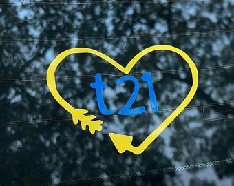 May include: A yellow heart-shaped sticker with a blue arrow and the text "t21" inside.
