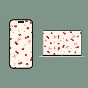 以下が含まれることがあります： クリーム色の背景に、ピンクのリボンが付いた赤いチェリーのパターンが描かれた、携帯電話とラップトップの画面です。