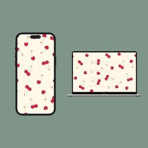 May include: A phone and laptop screen with a pattern of red cherries on a cream background.