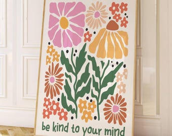 May include: A framed art print featuring a colorful floral design in pink, orange, and green. The artwork includes the text "be kind to your mind" in a green font. The print is displayed against a white wall.