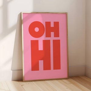 May include: A pink framed poster with the words "OH HI" in red letters.