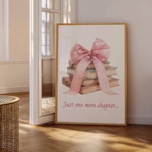 May include: A stack of books tied together with a large pink bow. The text "Just one more chapter..." is printed below the books.
