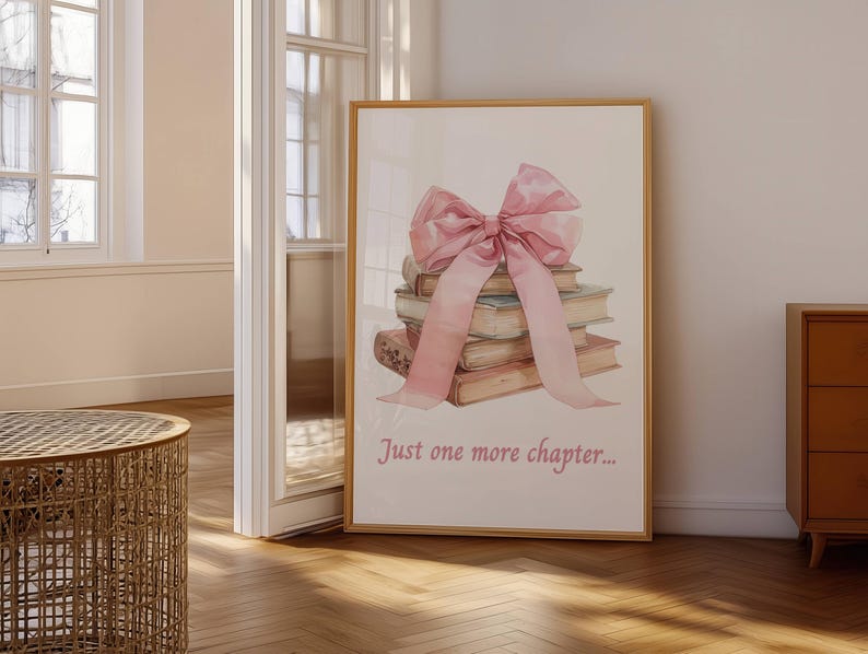 May include: A stack of books tied together with a large pink bow. The text "Just one more chapter..." is printed below the books.