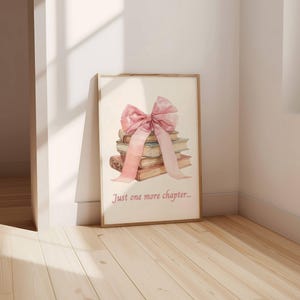 May include: A stack of books tied together with a large pink bow. The text "Just one more chapter..." is printed below the books.