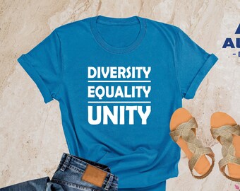 May include: A heather deep teal t-shirt with the words "Diversity, Equality, Unity" printed in white on the front. The shirt is shown on a model wearing blue jeans and sandals.