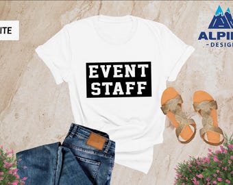 May include: White t-shirt with black text that says "EVENT STAFF" in a bold, blocky font.