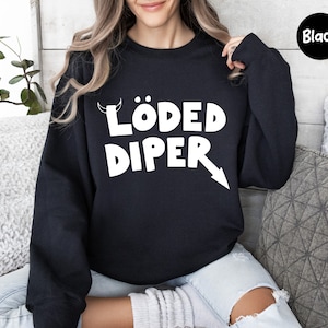 May include: Black sweatshirt with white text that reads "LÖDED DIPER" with a white devil horn and arrow graphic.
