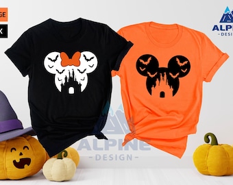 May include: Two t-shirts, one black and one orange, with a Mickey Mouse silhouette design featuring a castle and bats. The text "ALPINE - DESIGN -" is visible on the image.