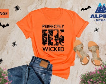 May include: Orange t-shirt with a black graphic that says "Perfectly Wicked" and features four cartoon witches.