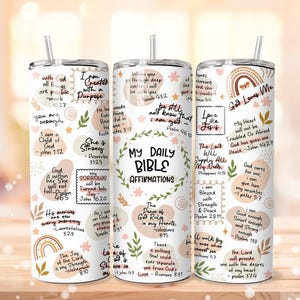 May include: A white tumbler with a straw, featuring the text "My Daily Bible Affirmations" and various inspirational quotes and illustrations in a pastel color palette. The tumbler is designed for cold beverages.